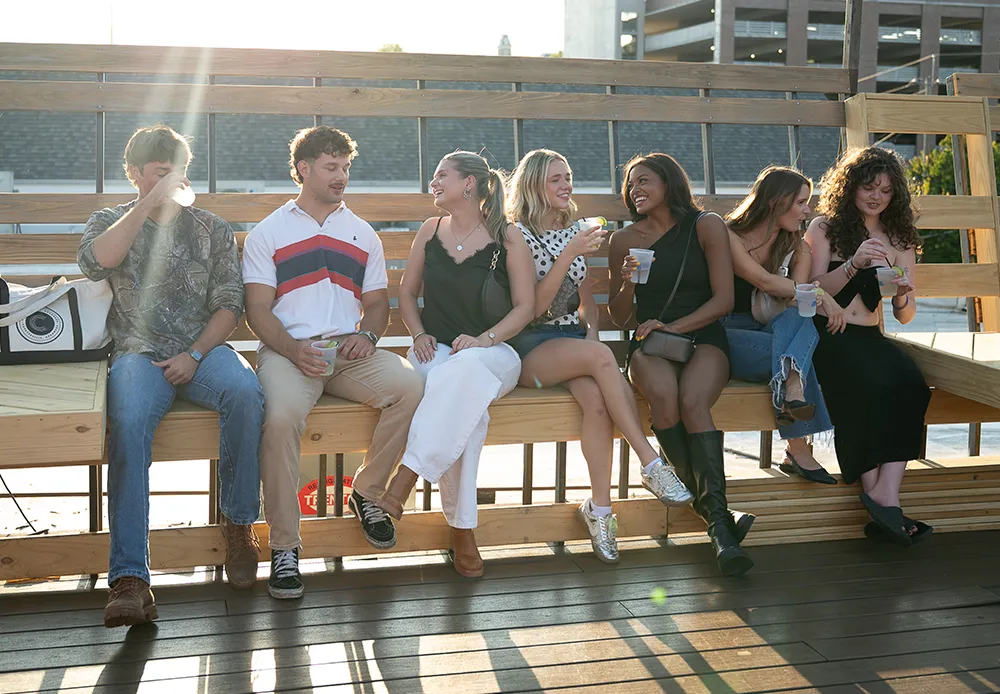 group of diverse young adult sitting outside